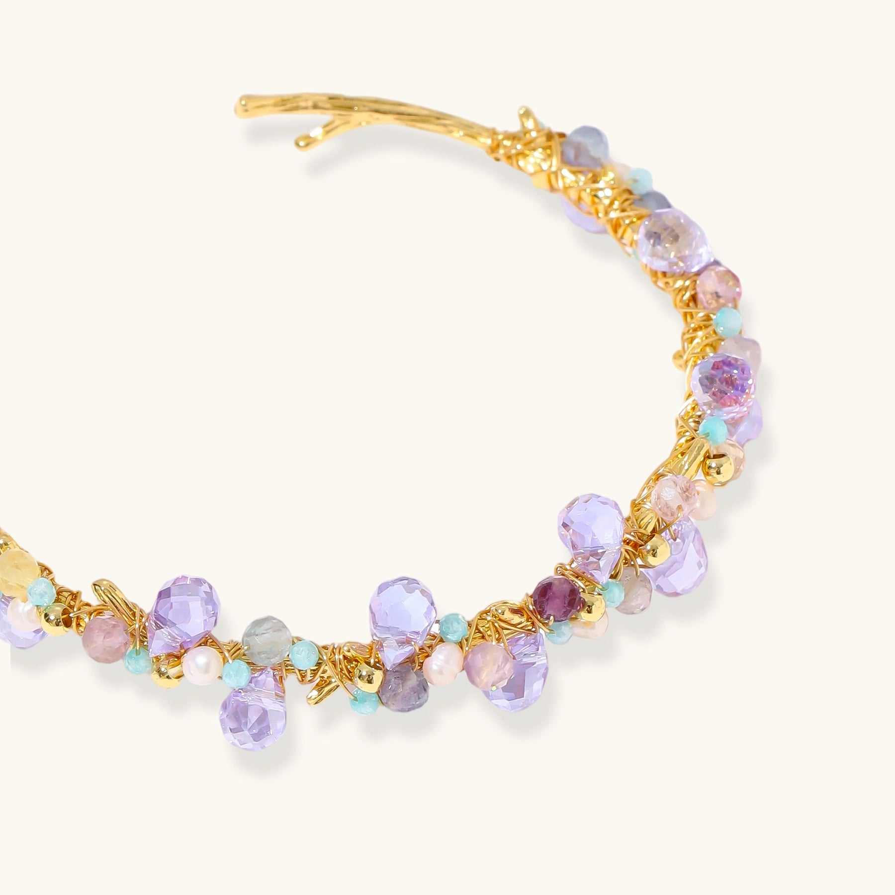 Gold-plated adjustable cuff bracelet with clustered lavender fluorite, turquoise beads, and freshwater pearls on white background.