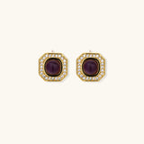 Gold-plated octagonal stud earrings with burgundy liuli centers and cubic zirconia halos on white background