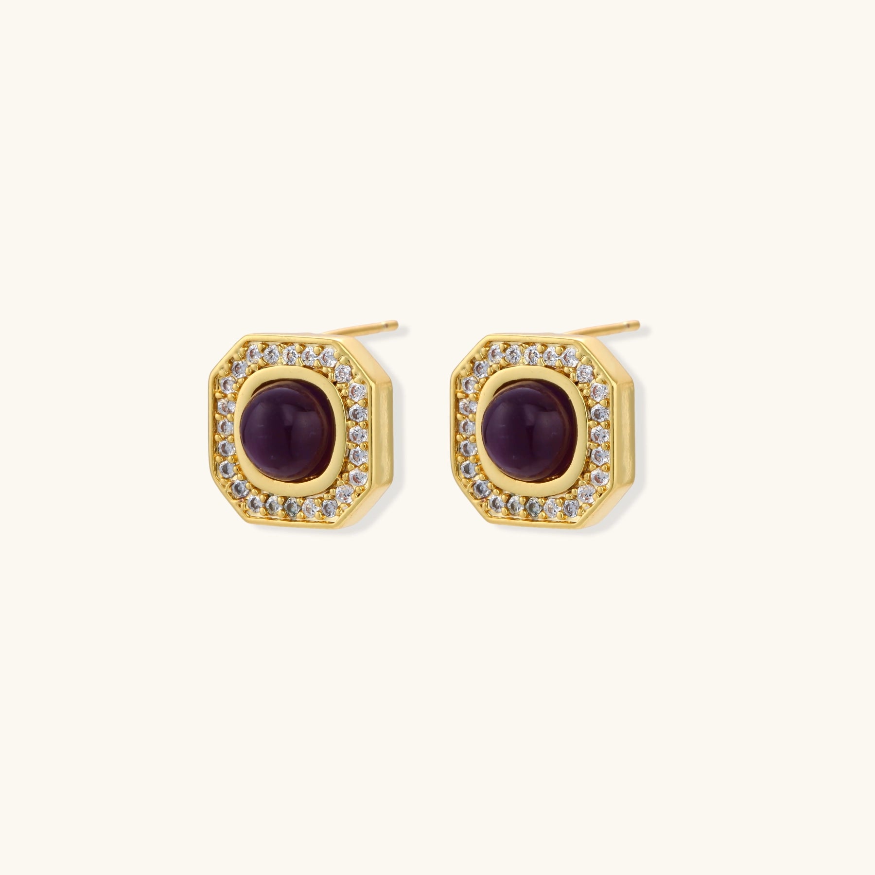 Gold-plated octagonal stud earrings with burgundy liuli centers and cubic zirconia halos on white background