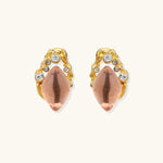 Gold-plated baroque stud earrings with coral-pink liuli stones and cubic zirconia crystals on white background.