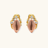 Gold-plated baroque stud earrings with coral-pink liuli stones and cubic zirconia crystals on white background.