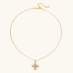 Gold-plated necklace with circular white enamel pendant featuring central zirconia stone and ornate decorative details
