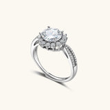 Close-up of sterling silver halo ring with brilliant round moissanite center stone surrounded by smaller accent stones