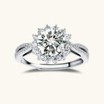 Close-up of sterling silver halo ring with brilliant round moissanite center stone surrounded by smaller accent stones