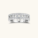 Wide sterling silver ring with three rows of brilliant moissanite stones in geometric pavé setting on white background