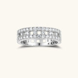 Wide sterling silver ring with three rows of brilliant moissanite stones in geometric pavé setting on white background