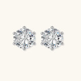 Close-up of round brilliant-cut moissanite stud earrings in 6-prong sterling silver settings showing exceptional sparkle