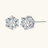 Close-up of round brilliant-cut moissanite stud earrings in 6-prong sterling silver settings showing exceptional sparkle
