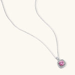 Sterling silver necklace with cushion-cut pink moissanite in diamond halo setting on white background
