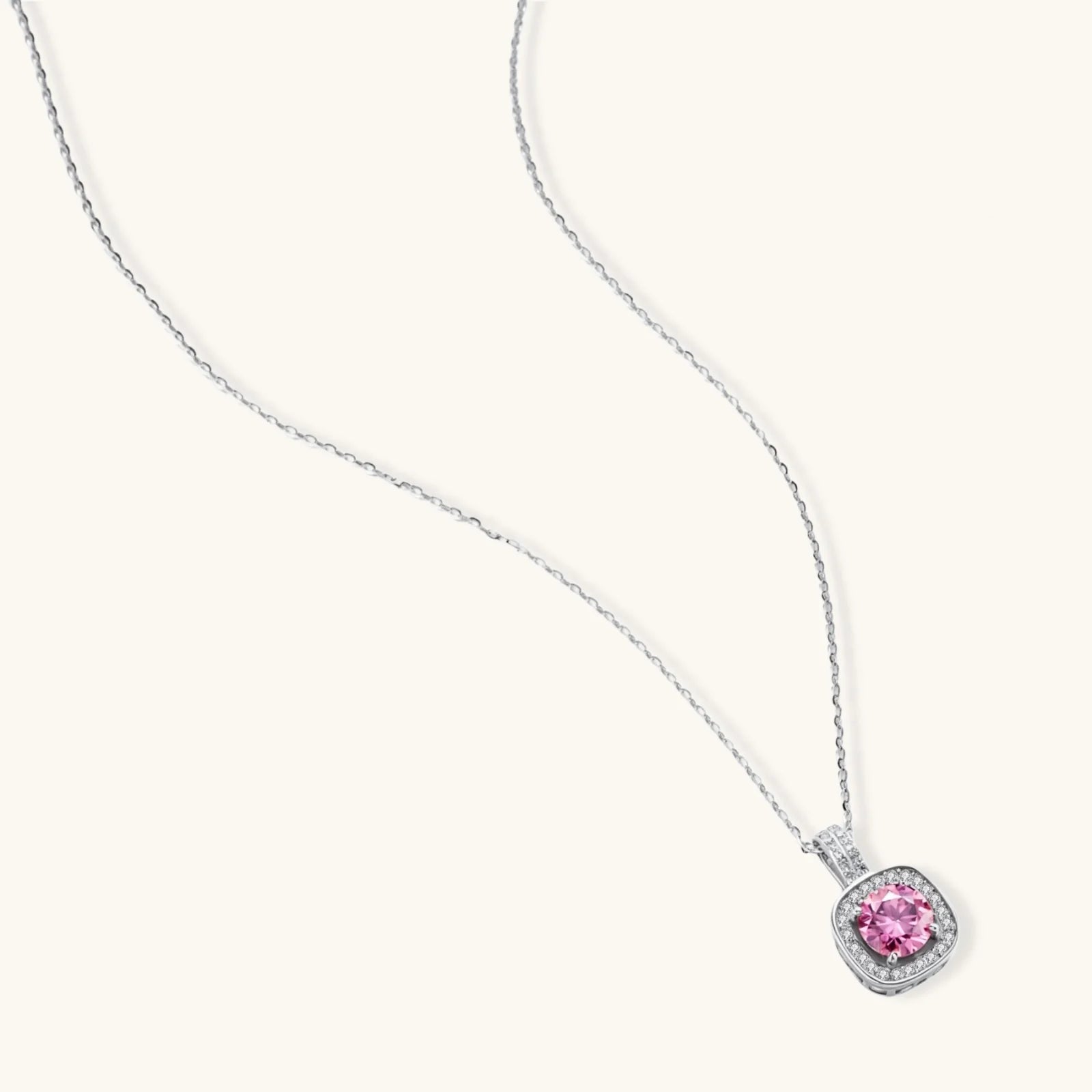 Sterling silver necklace with cushion-cut pink moissanite in diamond halo setting on white background