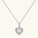 Sterling silver heart pendant necklace with brilliant moissanite center stone and halo setting on delicate chain