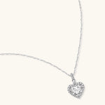 Sterling silver heart pendant necklace with brilliant moissanite center stone and halo setting on delicate chain