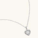 Sterling silver heart pendant necklace with brilliant moissanite center stone and halo setting on delicate chain