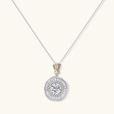 Sterling silver necklace with circular geometric pendant featuring central moissanite and radial baguette pattern.