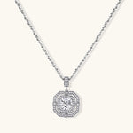 Sterling silver octagonal pendant necklace with brilliant moissanite center stone and halo setting on white background.