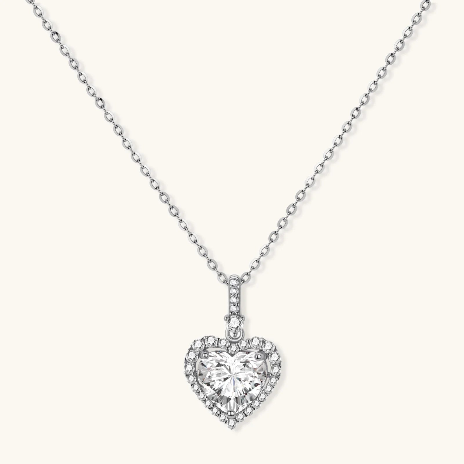 Complete jewelry set with heart-shaped sterling silver pieces featuring brilliant moissanite stones on white background.