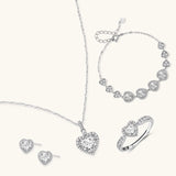 Complete jewelry set with heart-shaped sterling silver pieces featuring brilliant moissanite stones on white background.