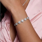 Complete jewelry set with heart-shaped sterling silver pieces featuring brilliant moissanite stones on white background.