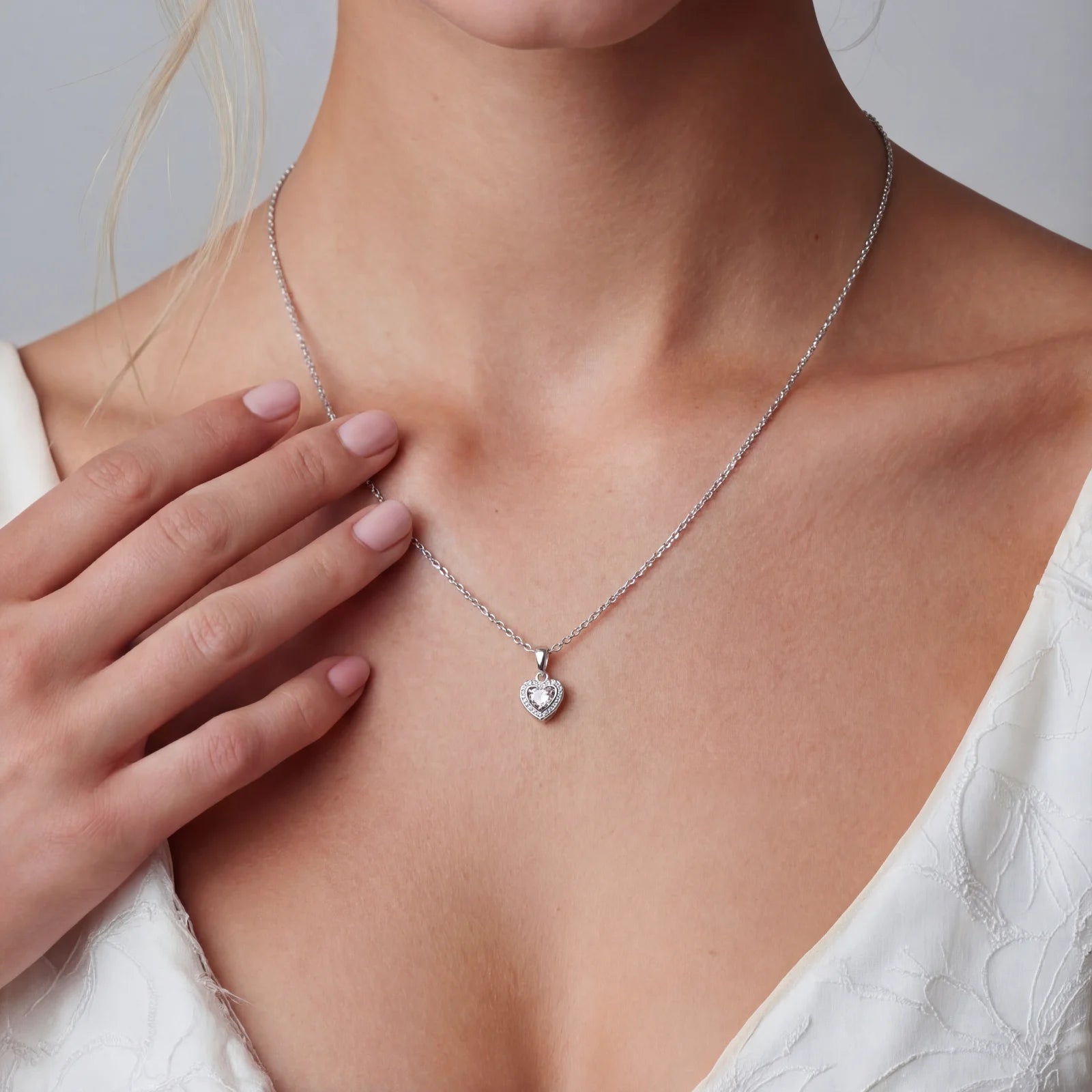 Complete jewelry set with heart-shaped sterling silver pieces featuring brilliant moissanite stones on white background.