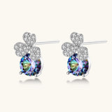 Sterling silver stud earrings with four-leaf clover design featuring small crystals above round moissanite stones