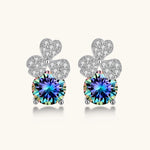 Sterling silver stud earrings with four-leaf clover design featuring small crystals above round moissanite stones