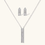 White gold plated necklace with vertical cubic zirconia pendant and matching hoop earrings on neutral background