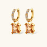 14K gold plated jewelry set featuring square champagne CZ stones with sparkling huggie earrings on cream background.