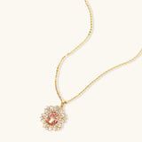 Ornate gold-plated jewelry set featuring peach center stone surrounded by clear AAA cubic zirconia crystals