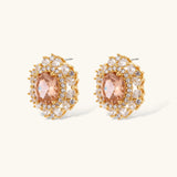 Ornate gold-plated jewelry set featuring peach center stone surrounded by clear AAA cubic zirconia crystals