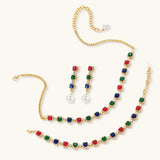 Gold-plated jewelry set with red, green, and blue cubic zirconia stones including necklace, bracelet, and drop earrings.