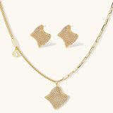 Gold-plated wavy jewelry set with crystal detailing featuring necklace with dual chains and matching textured earrings