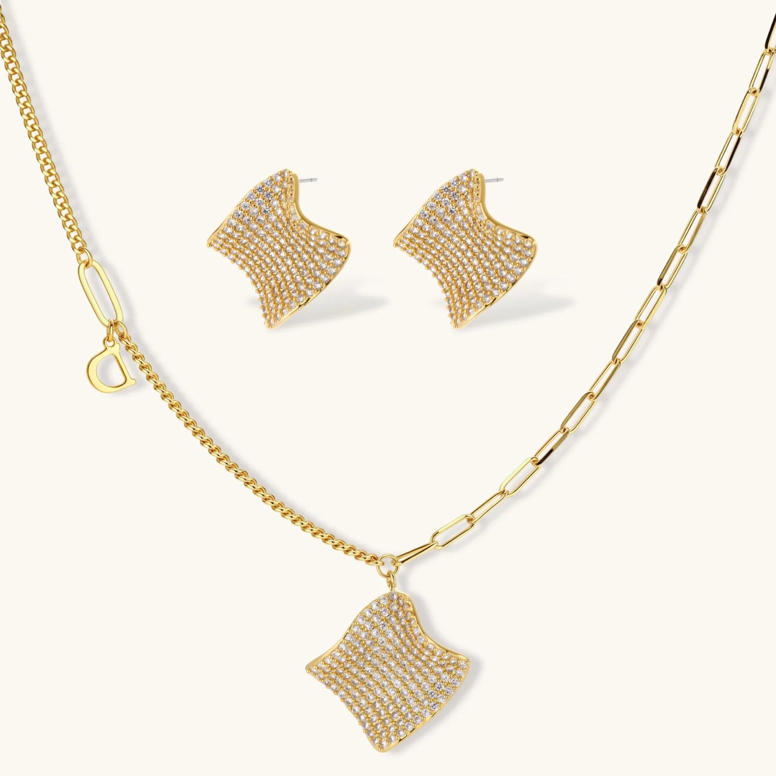 Gold-plated wavy jewelry set with crystal detailing featuring necklace with dual chains and matching textured earrings