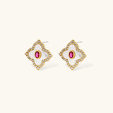 Gold-plated quatrefoil necklace and earring set with white enamel, pink cubic zirconia centers, and crystal borders