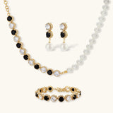 Gold-plated jewelry set with alternating black and clear cubic zirconia stones, featuring necklace, earrings and bracelet
