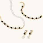 Gold-plated jewelry set with alternating black and clear cubic zirconia stones, featuring necklace, earrings and bracelet