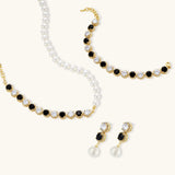Gold-plated jewelry set with alternating black and clear cubic zirconia stones, featuring necklace, earrings and bracelet