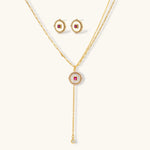 Gold-plated circular medallion necklace set with white enamel base and pink cubic zirconia accent stones