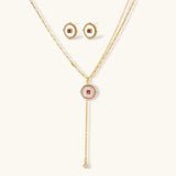 Gold-plated circular medallion necklace set with white enamel base and pink cubic zirconia accent stones
