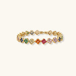 Colorful four-leaf clover jewelry set with rainbow cubic zirconia stones in gold-plated setting on white background
