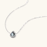 Elegant spherical pendant necklace and earrings set featuring crystal-pavé bottom half in gold or silver finish on white background.