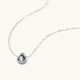 Elegant spherical pendant necklace and earrings set featuring crystal-pavé bottom half in gold or silver finish on white background.