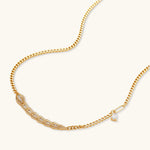 Gold-plated necklace with geometric diamond segments and matching huggie earrings featuring cubic zirconia details