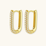 Close-up of small sterling silver huggie hoops completely covered in sparkling clear crystals with hinged closure