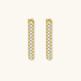 Close-up of small sterling silver huggie hoops completely covered in sparkling clear crystals with hinged closure