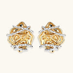Sculptural rose-shaped stud earrings in gold with silver wire details and S925 posts on cream background.