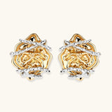 Sculptural rose-shaped stud earrings in gold with silver wire details and S925 posts on cream background.