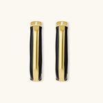 Modern hoop earrings with gold-plated and black sections, featuring hinged closure on white background.