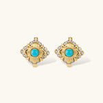 Close-up of 18K gold plated hoop earrings with turquoise center stones and zircon crystals in quatrefoil flower design