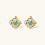Close-up of 18K gold plated hoop earrings with turquoise center stones and zircon crystals in quatrefoil flower design