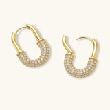 Gold-plated huggie hoop earrings with pavé zirconia stones covering the bottom curve, shown in open and closed positions.